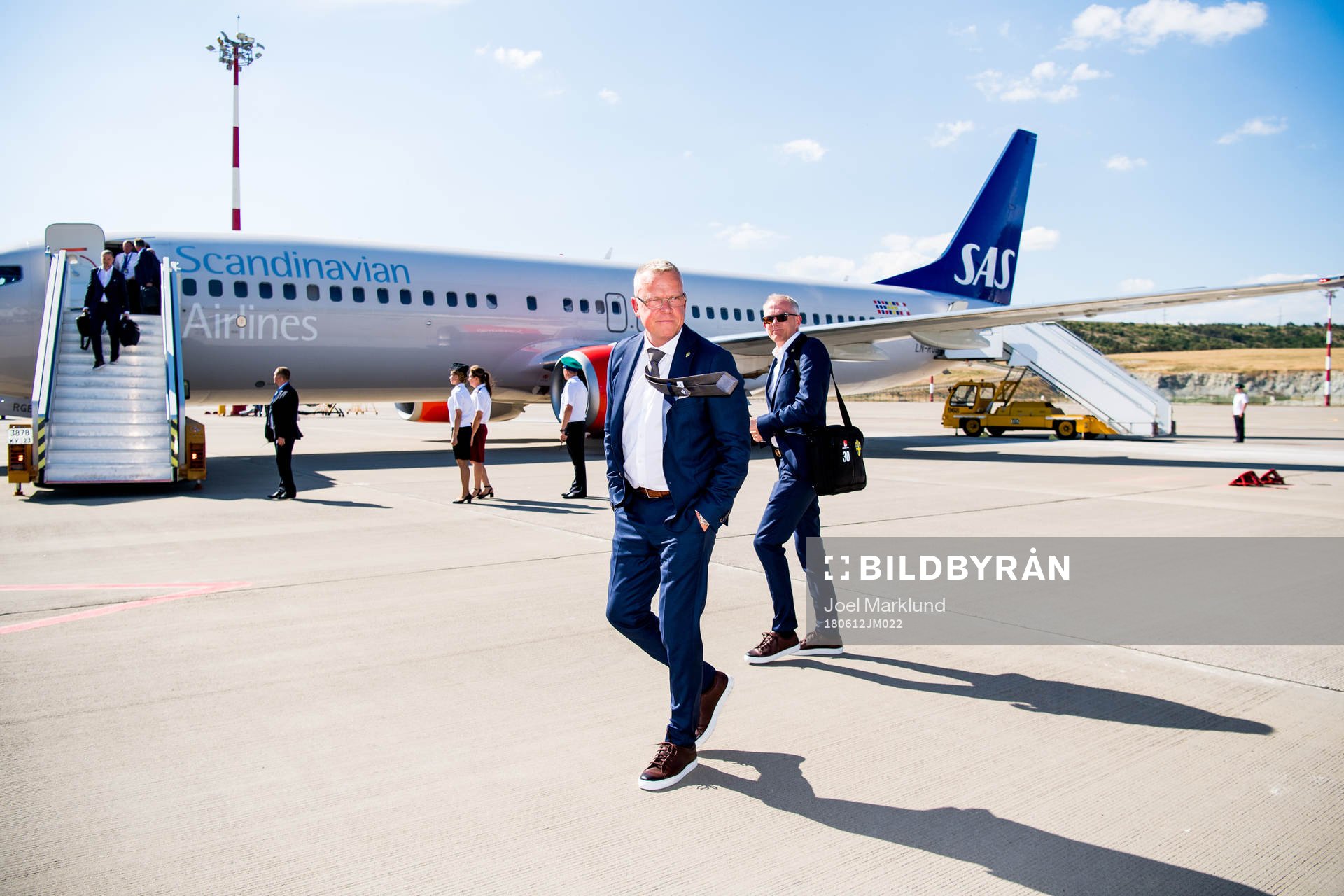 Head coach Janne Andersson walks in front of the plane when