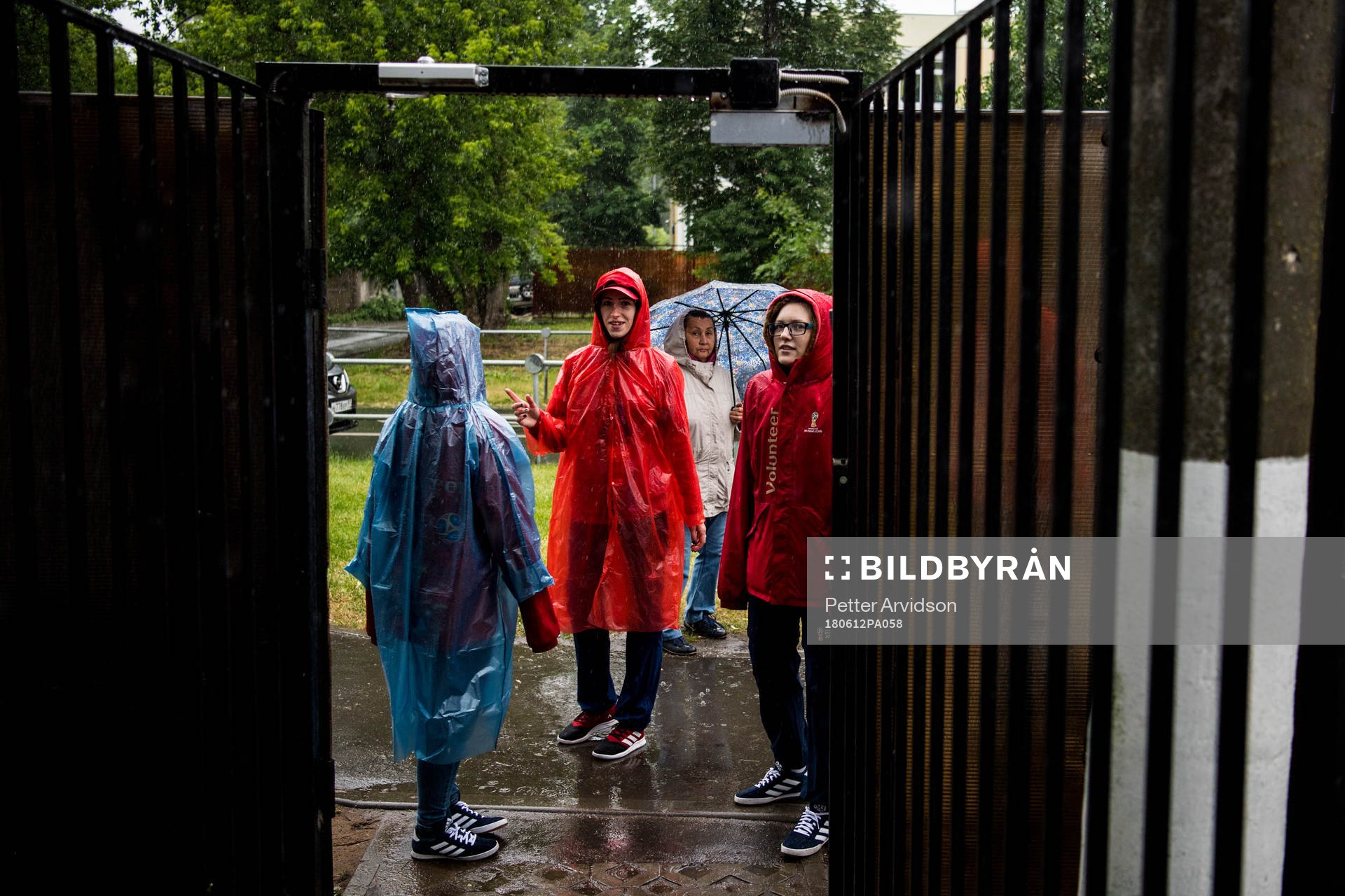 Volunteers is seen in the heavy rain prior team Mexico