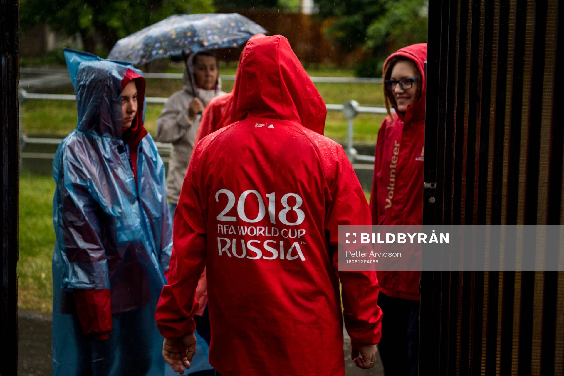 Volunteers is seen in the heavy rain prior team Mexico