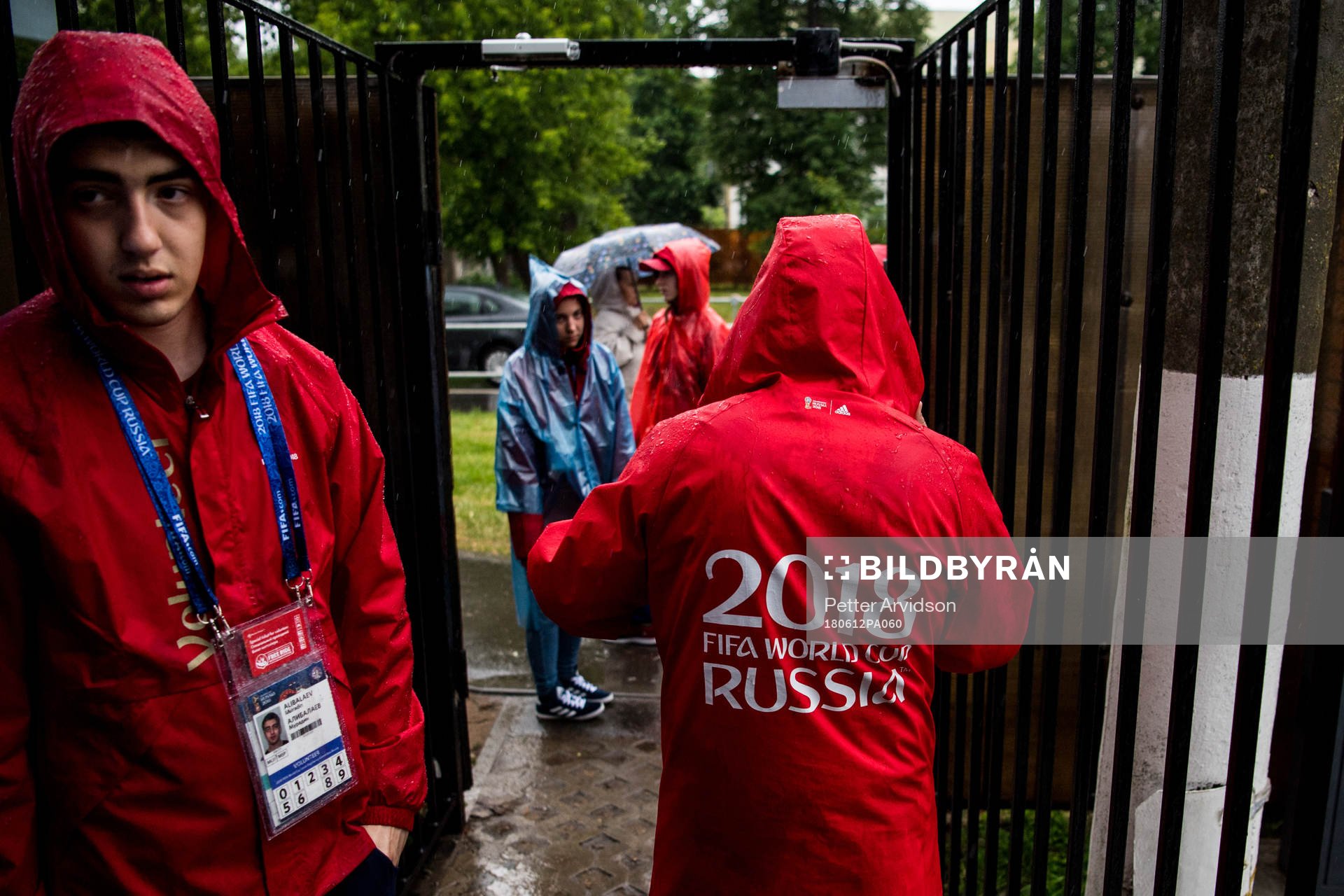 Volunteers is seen in the heavy rain prior team Mexico