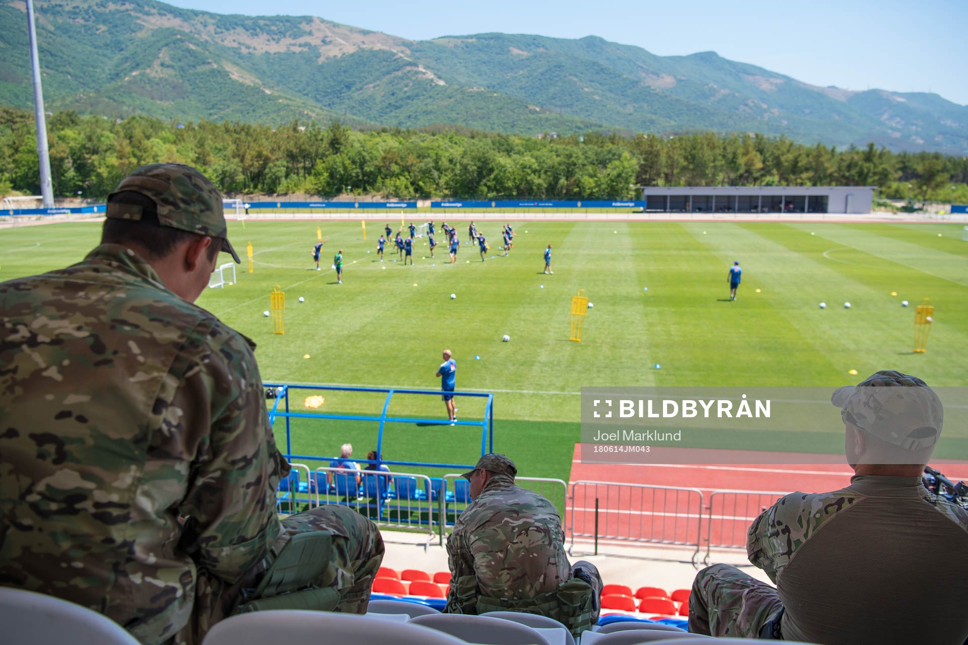 Military personal watch the Swedish national football