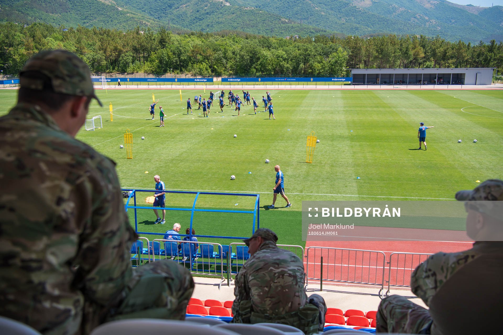 Military personal watch the Swedish national football