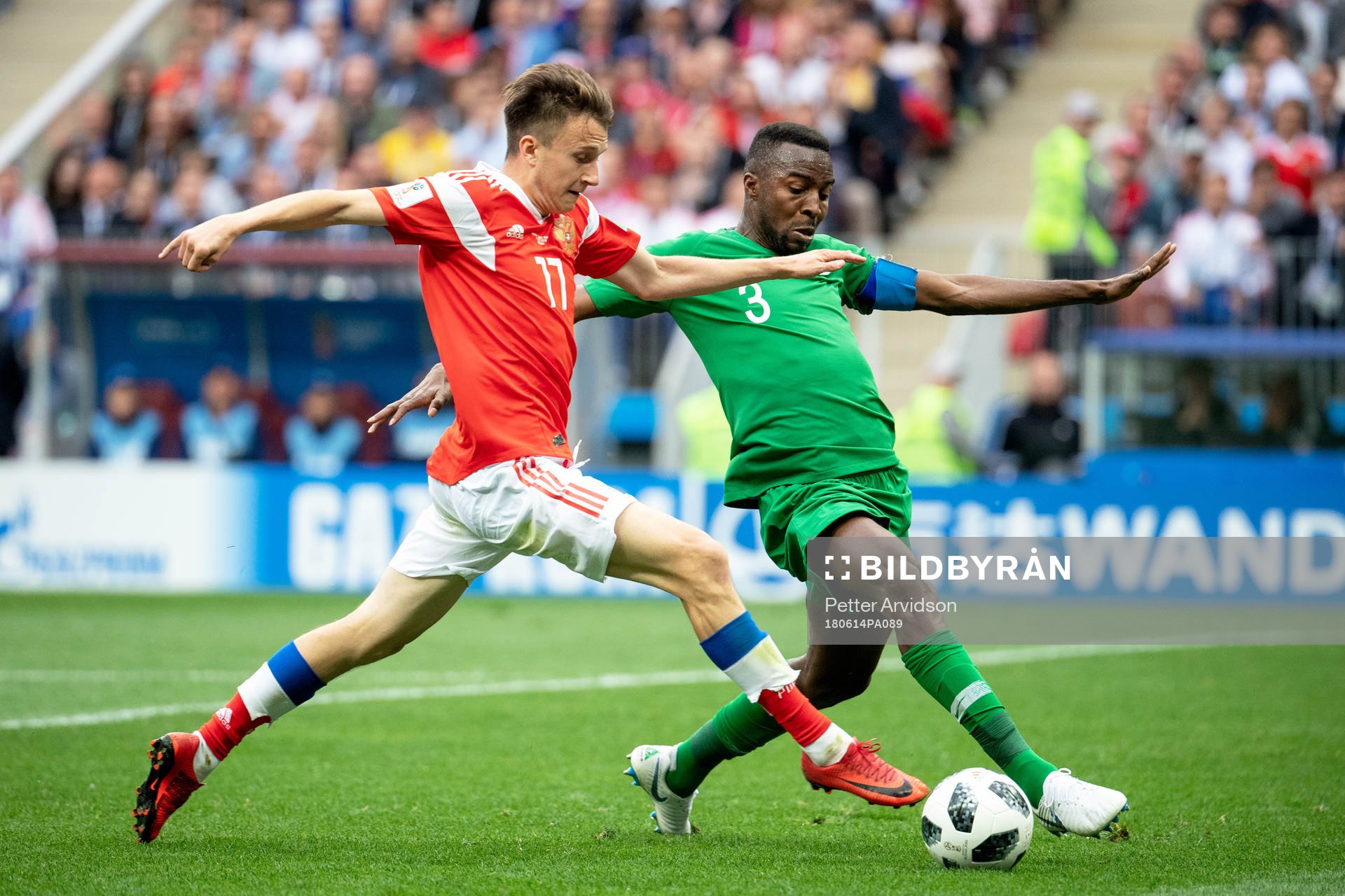 Aleksandr Golovin of Russia and Osama Hawsawi of Saudiarabia during the FIFA World Cup group stage match between Russia and Saudi Arabia on June 14, 2018 in Moscow.