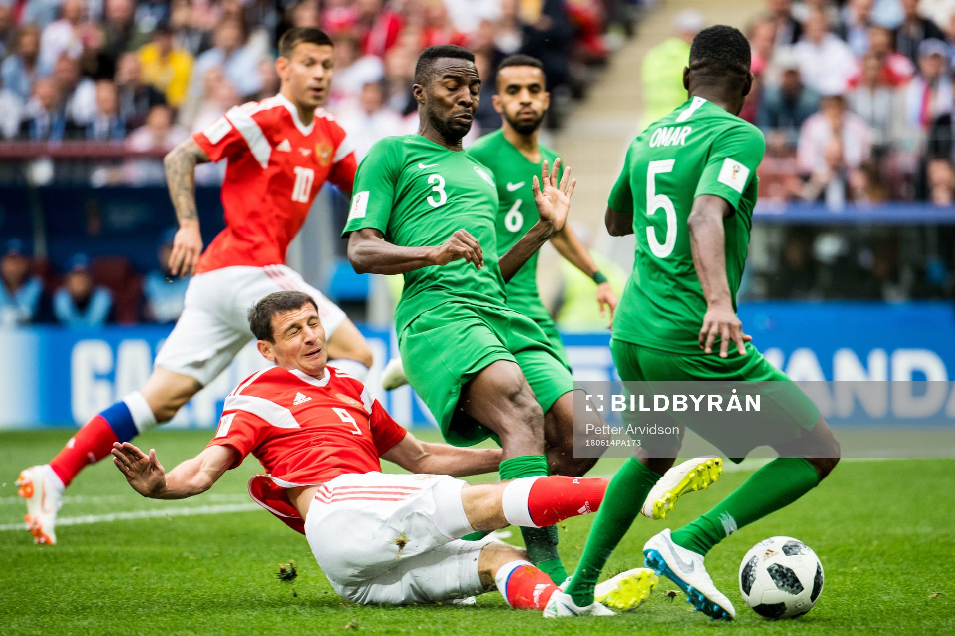 Alan Dzagoev of Russia and Osama Hawsawi of Saudi Arabia during the FIFA World Cup group stage match between Russia and Saudi Arabia on June 14, 2018 in Moscow.