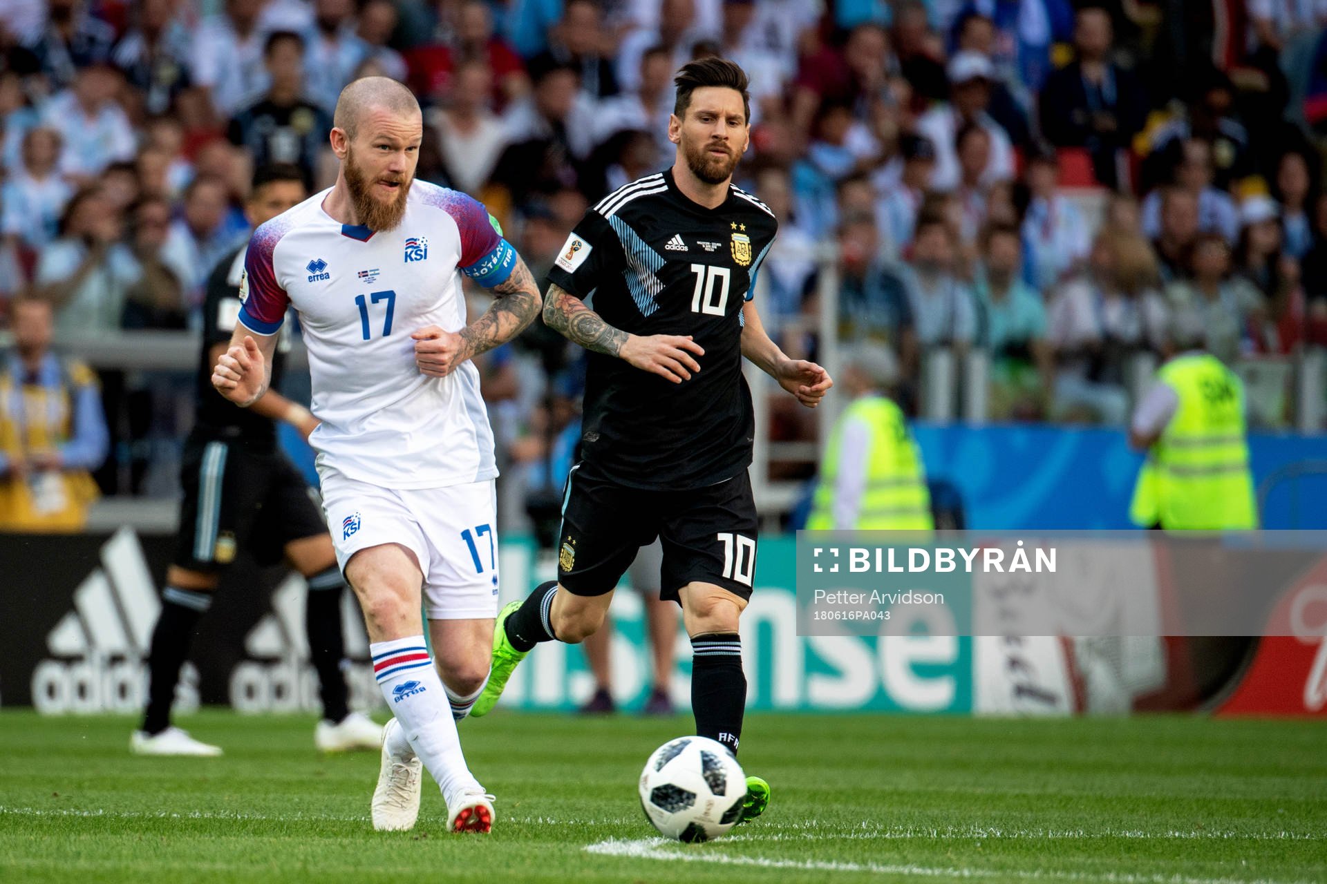 Aron Gunnarsson of Iceland and Lionel Messi of Argentina