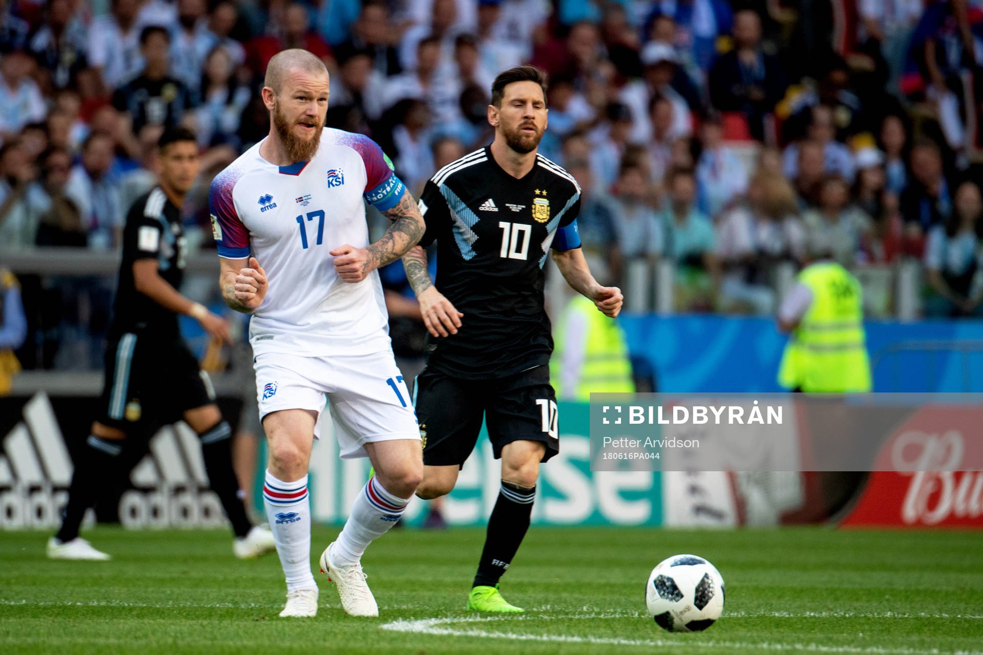 Aron Gunnarsson of Iceland and Lionel Messi of Argentina