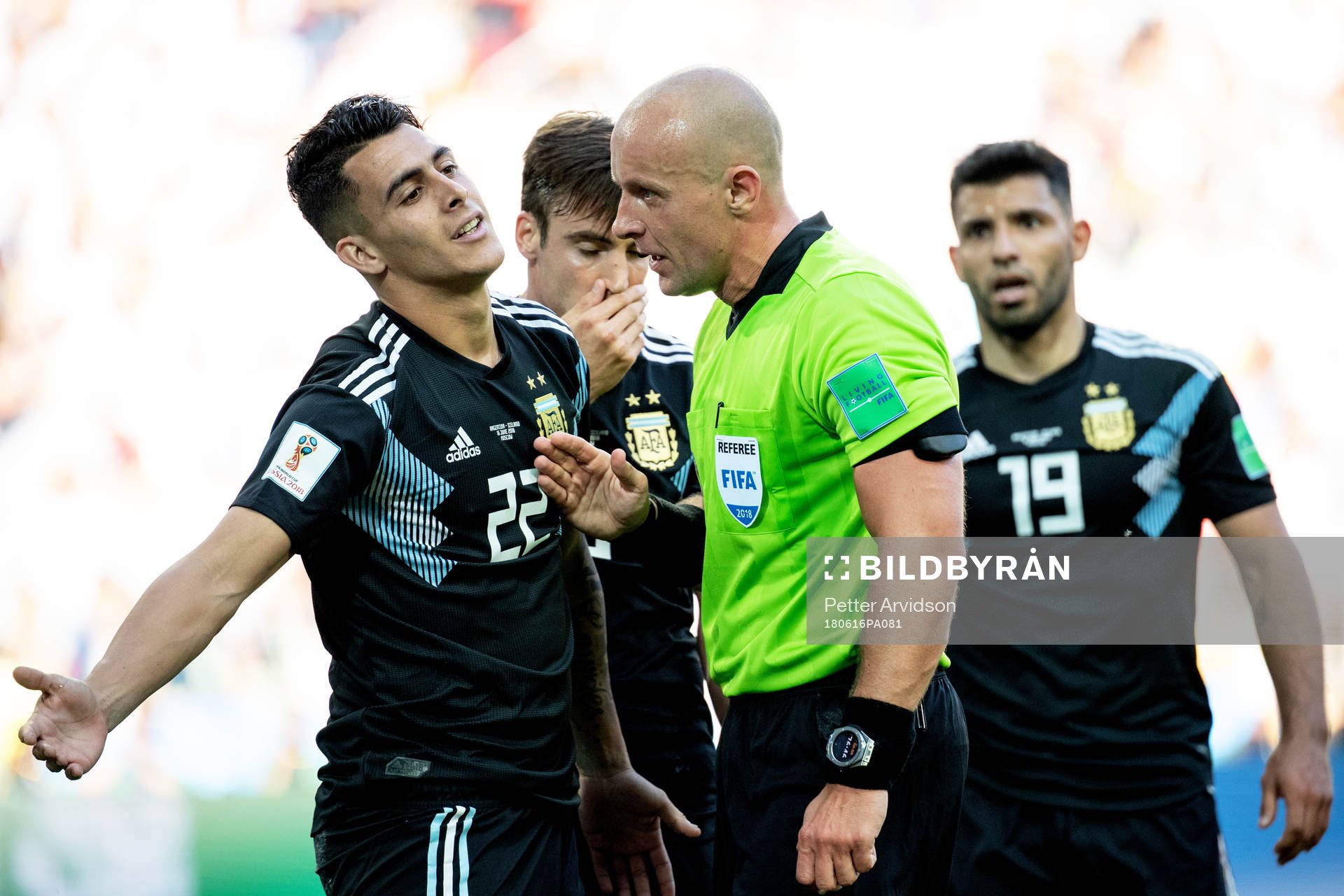 referee Szymon Marciniak talks to Cristian Pavon of
