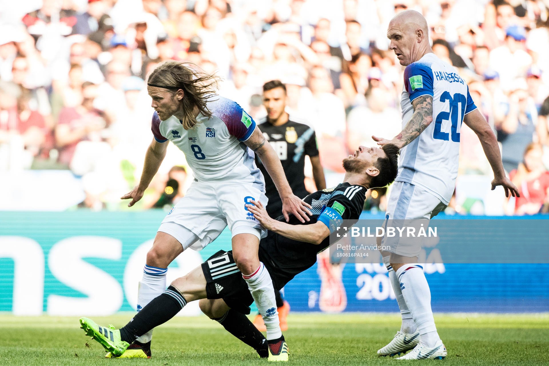 Birkir Bjarnason of Iceland stops Lionel Messi of Argentina