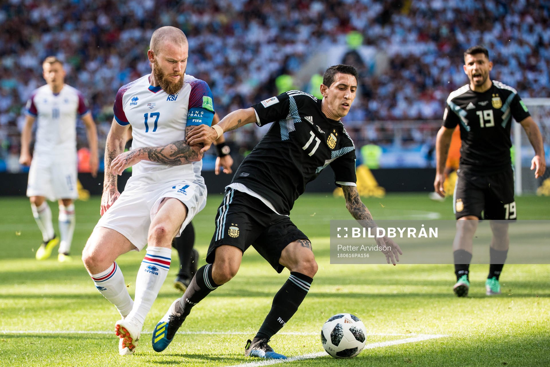 Aron Gunnarsson of Iceland in action with Angel Di Maria of