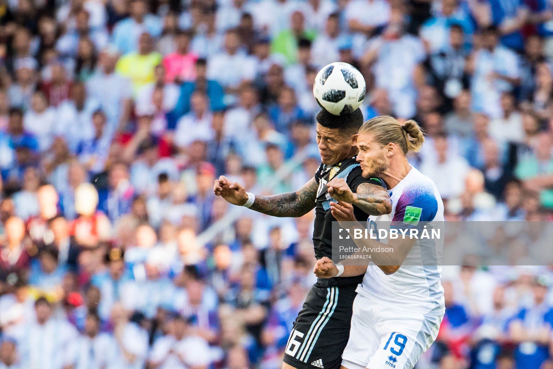 Marcos Rojo of Argentina in action with Rurik Gislason of