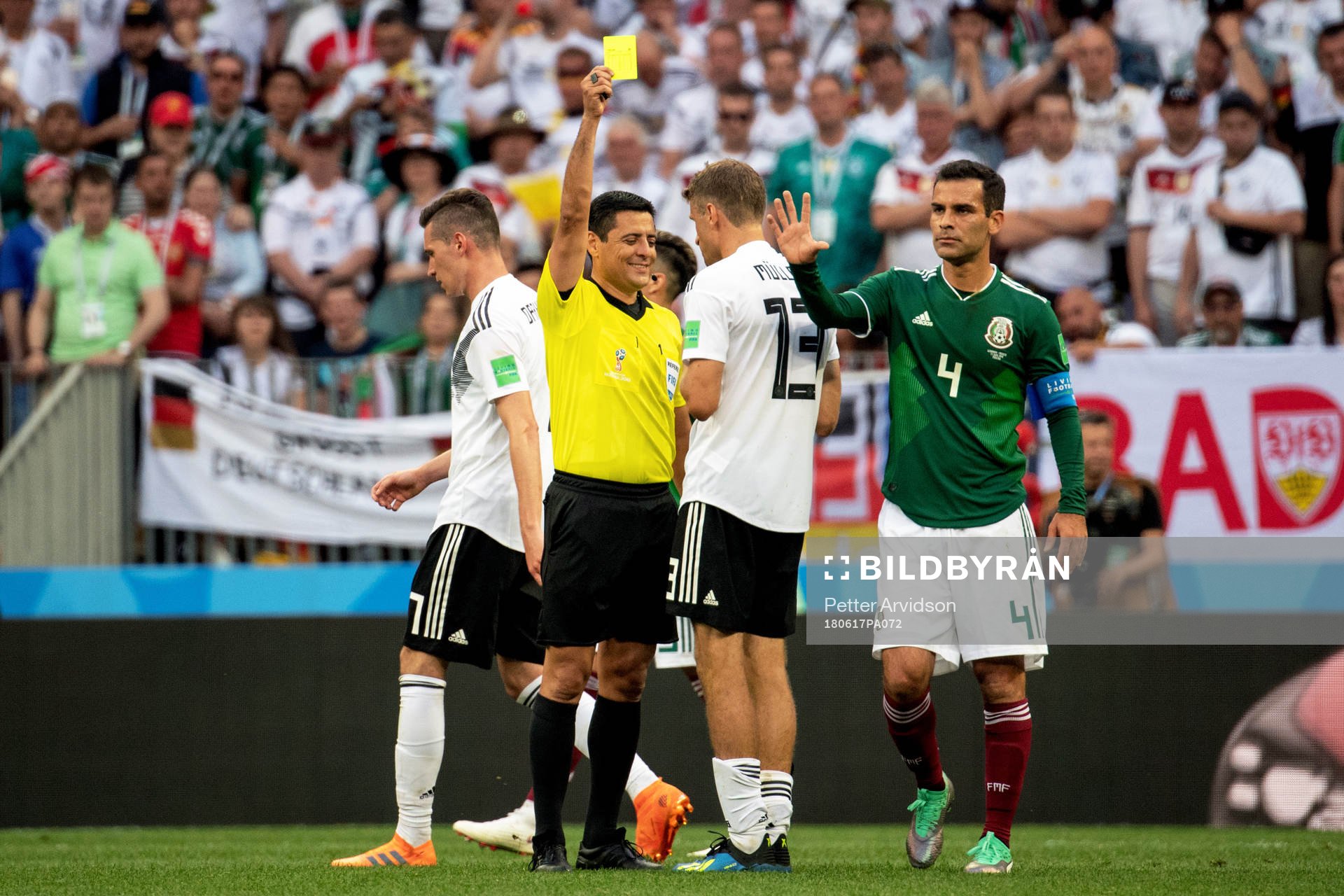 Thomas Müller of Germany is shown a yellow card by referee