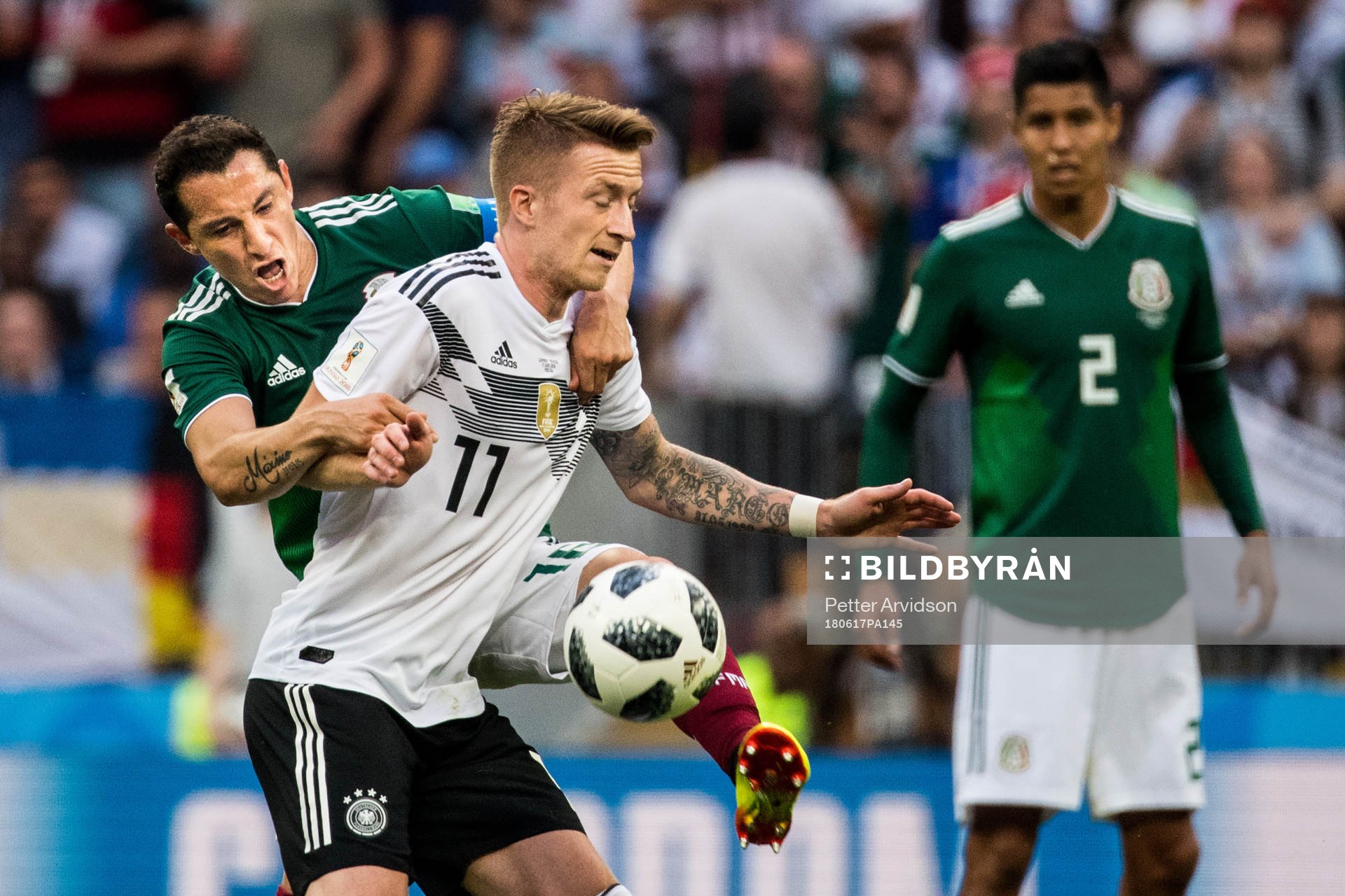 Marco Reus of Germany in action with Andres Guardado of