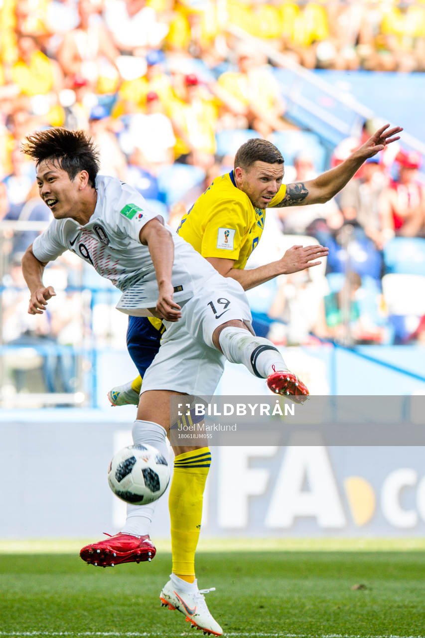 Younggwon Kim of South Korea and Marcus Berg of Sweden