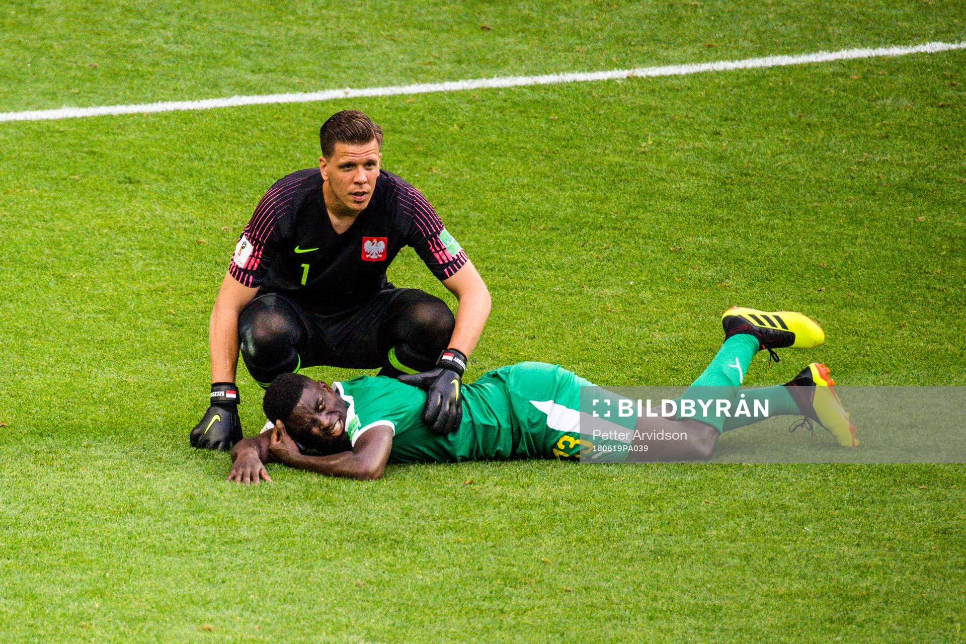 Alfred Ndiaye of Senegal in pain next to goalkeeper