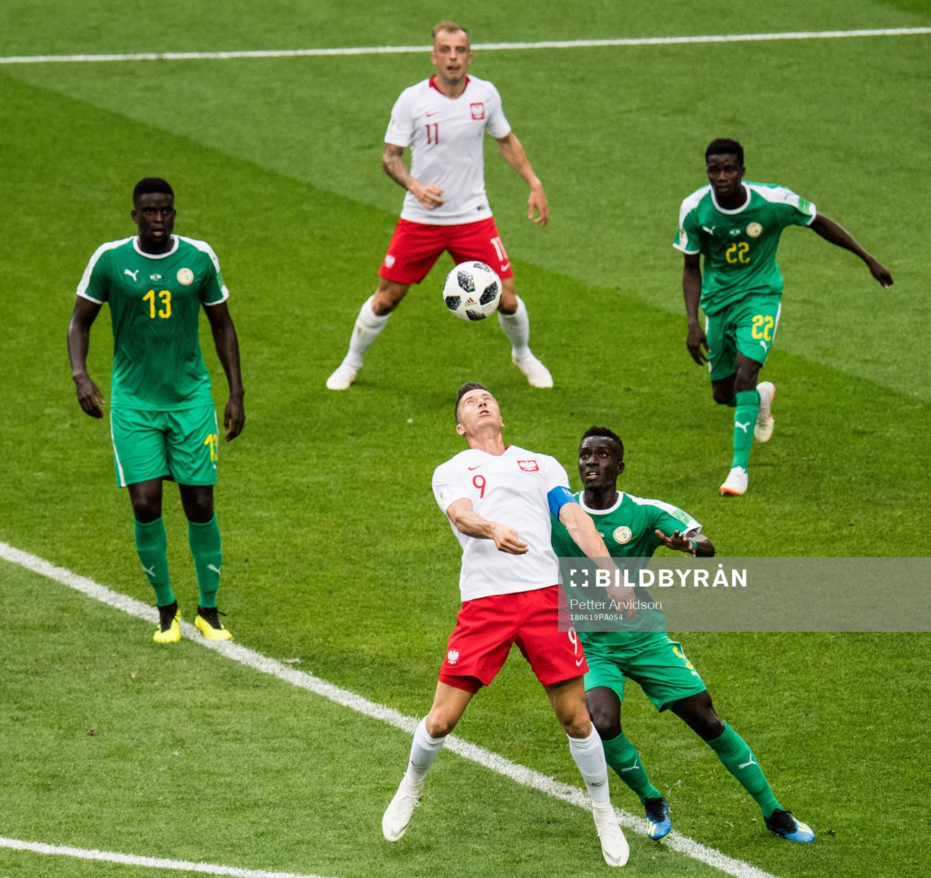 Robert Lewandowski of Poland and Idrissa Gana Gueye of