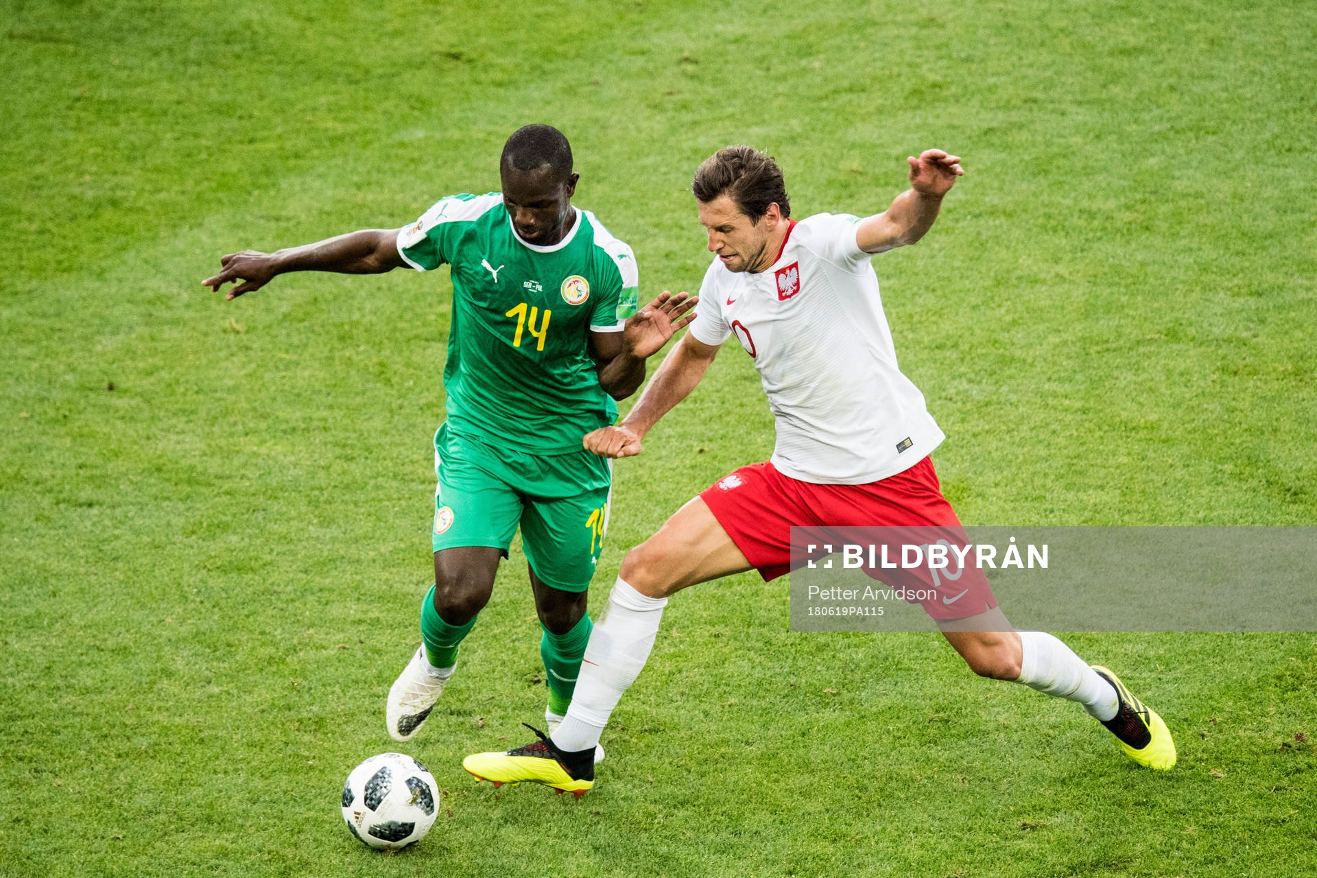 Moussa Konate of Senegal and Grzegorz Krychowiak of Poland