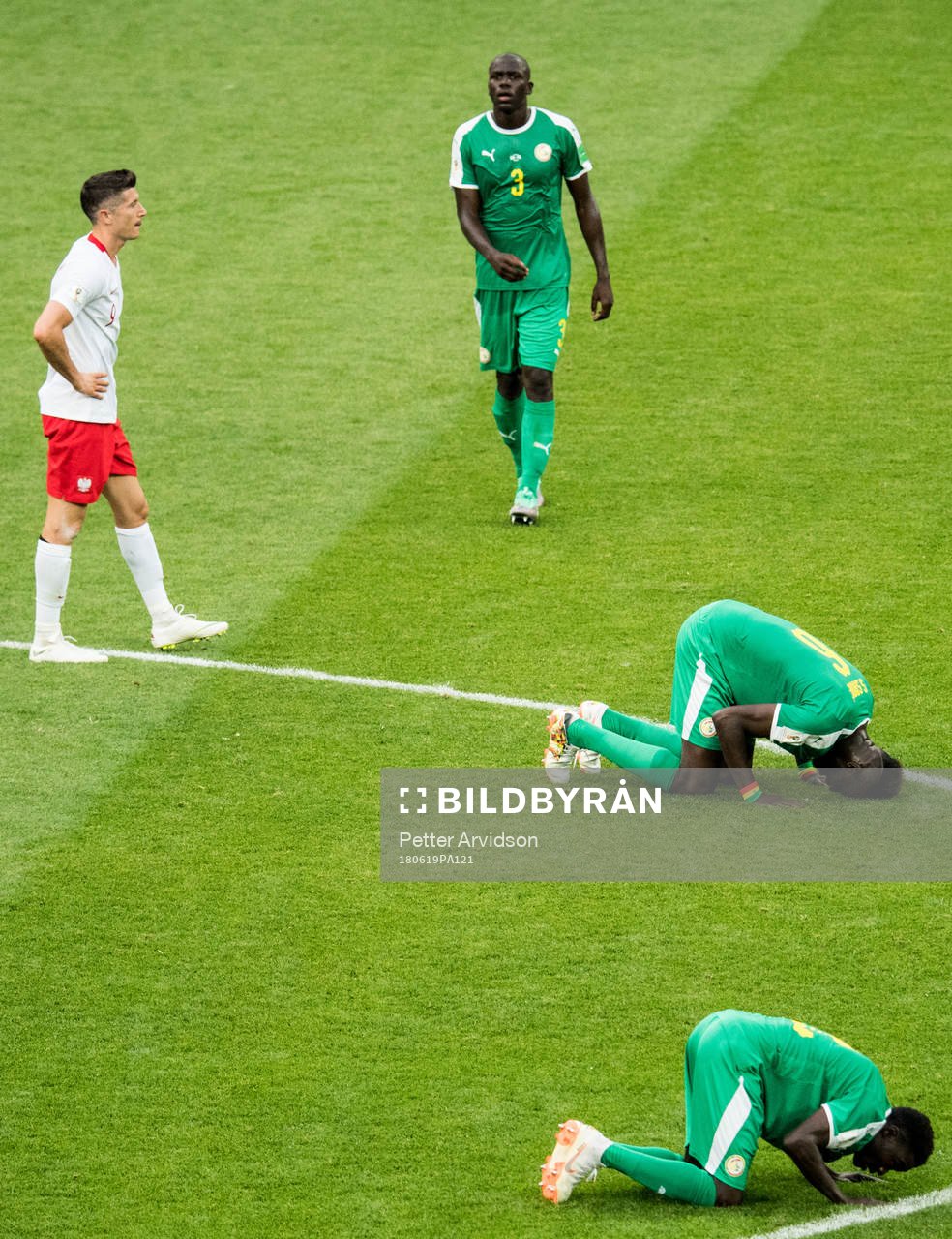 Robert Lewandowski of Poland looks dejected and players of