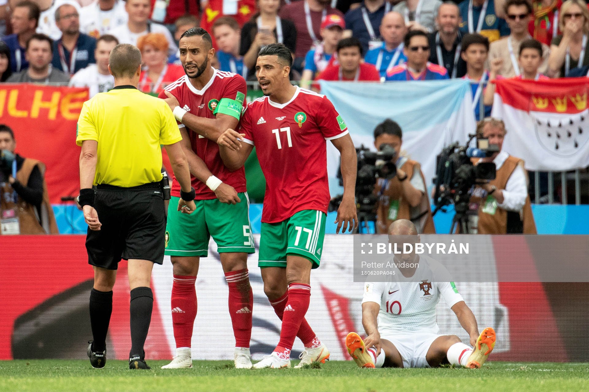 Mehdi Benatia and Nabil Dirar of Morocco and referee Mark Geiger during the FIFA World Cup group stage match between Portugal and Morocco on June 20, 2018 in Moscow.