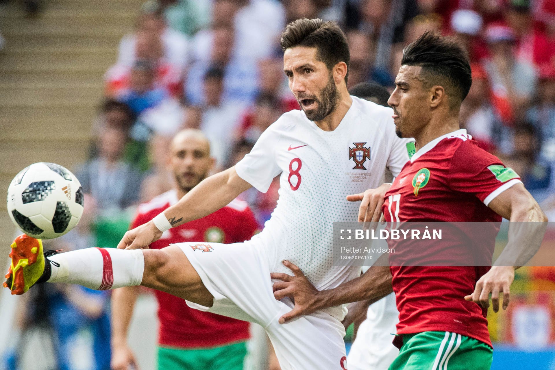 Joao Moutinho of Portugal in action with Nabil Dirar of Morocco during the FIFA World Cup group stage match between Portugal and Morocco on June 20, 2018 in Moscow.