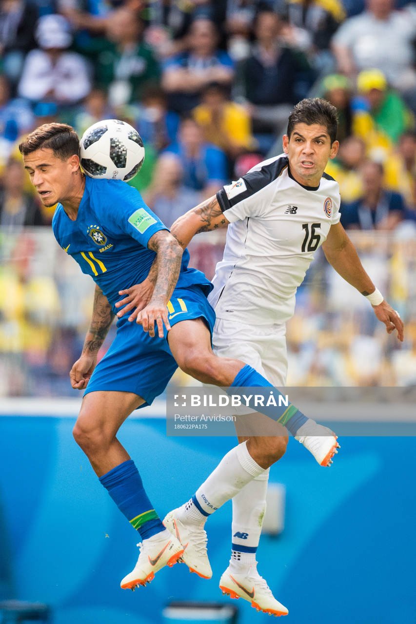 Philippe Coutinho of Brazil in action with Cristian Gamboa