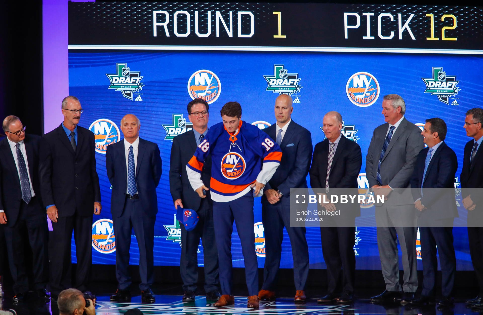 Noah Dobson of Canada poses with team representatives