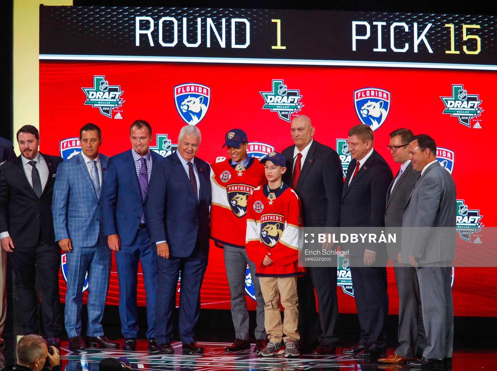 Grigori Denisenko of Russia poses with team representatives