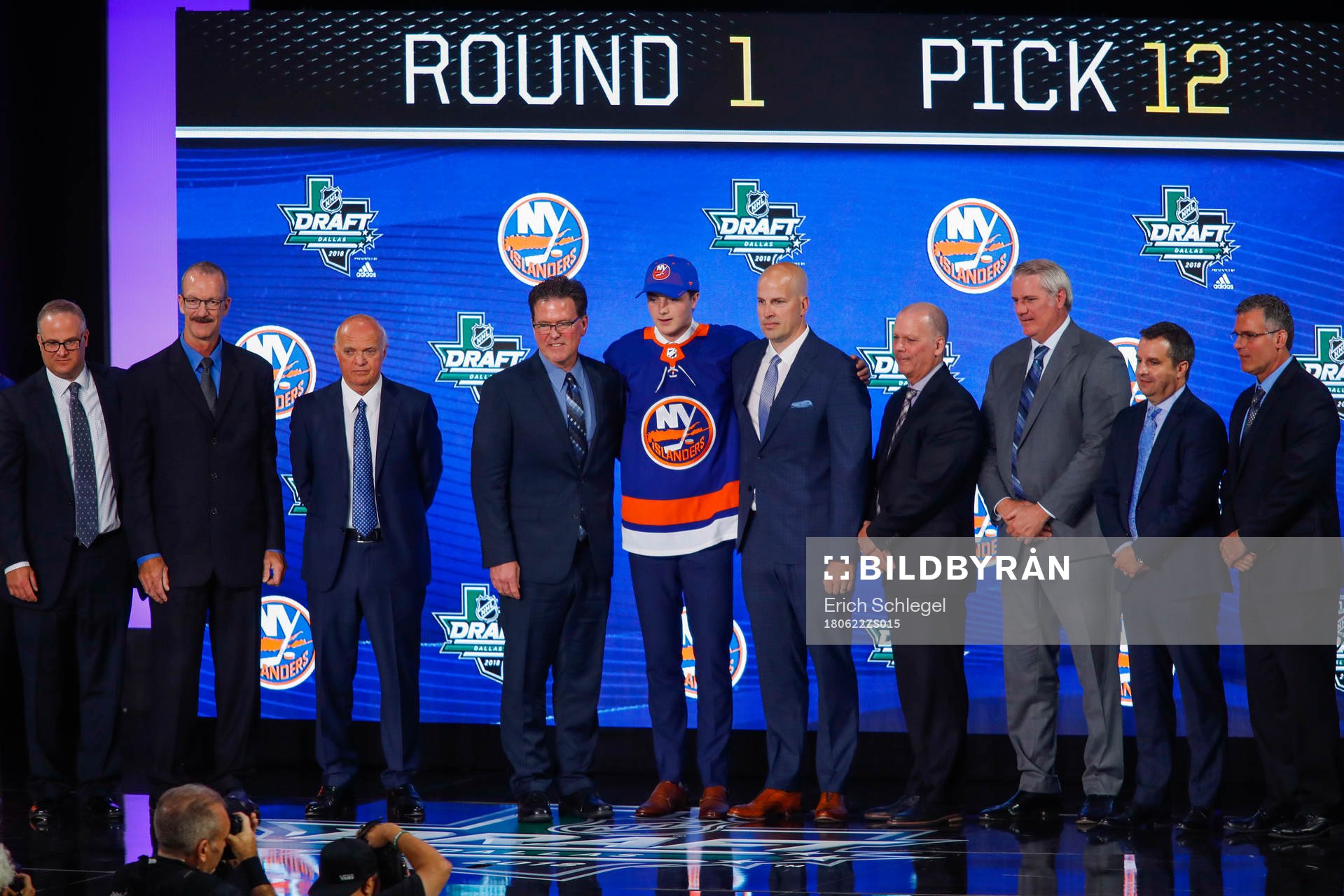 Noah Dobson of Canada poses with team representatives