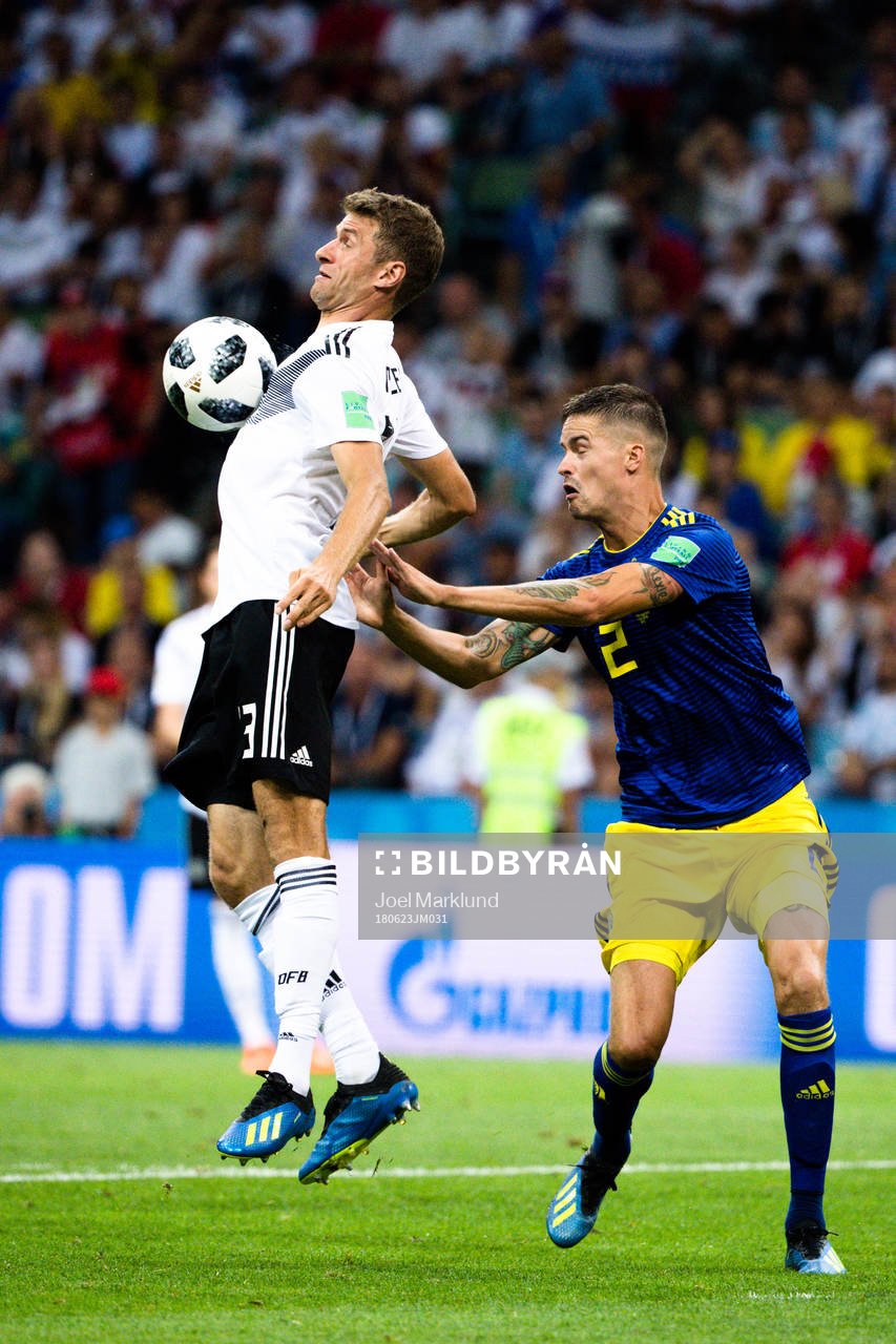 Thomas Müller of Germany and Mikael Lustig of Sweden