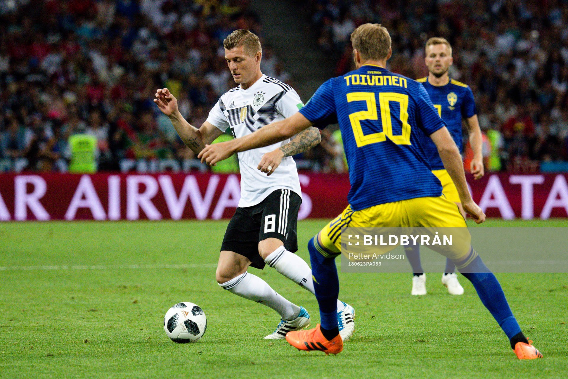 Toni Kroos of Germany and Ola Toivonen of Sweden