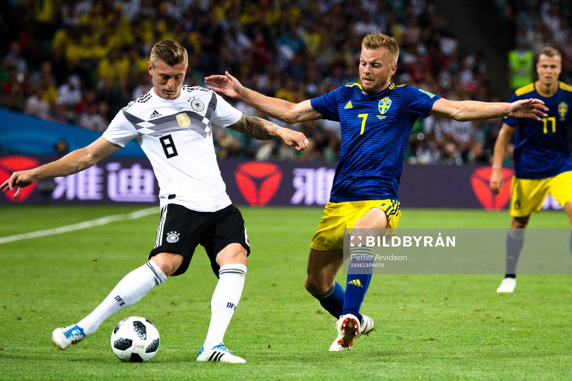 Toni Kroos of Germany and Sebastian Larsson of Sweden