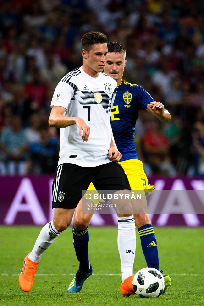 Julian Draxler  of Germany and Mikael Lustig of Sweden