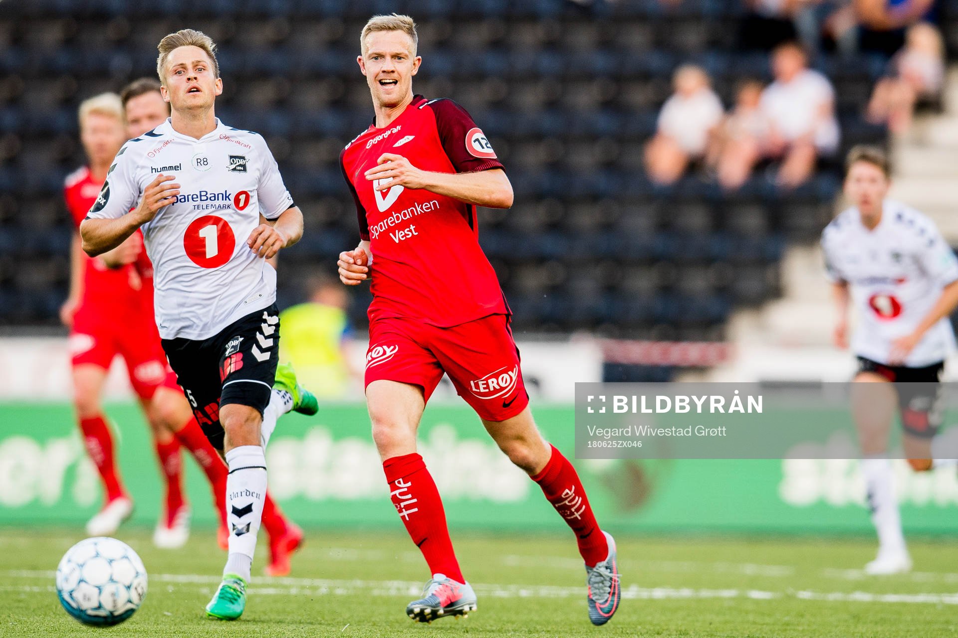 Thomas Grøgaard of Odd and Peter Orry Larsen of Brann during the Eliteserien match between Odd and Brann on June 25, 2018 in Skien.