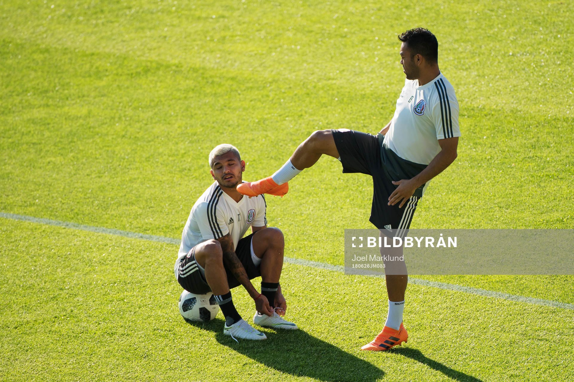 Marco Fabian (R) pretends to kick Jesus Corona (L) of the