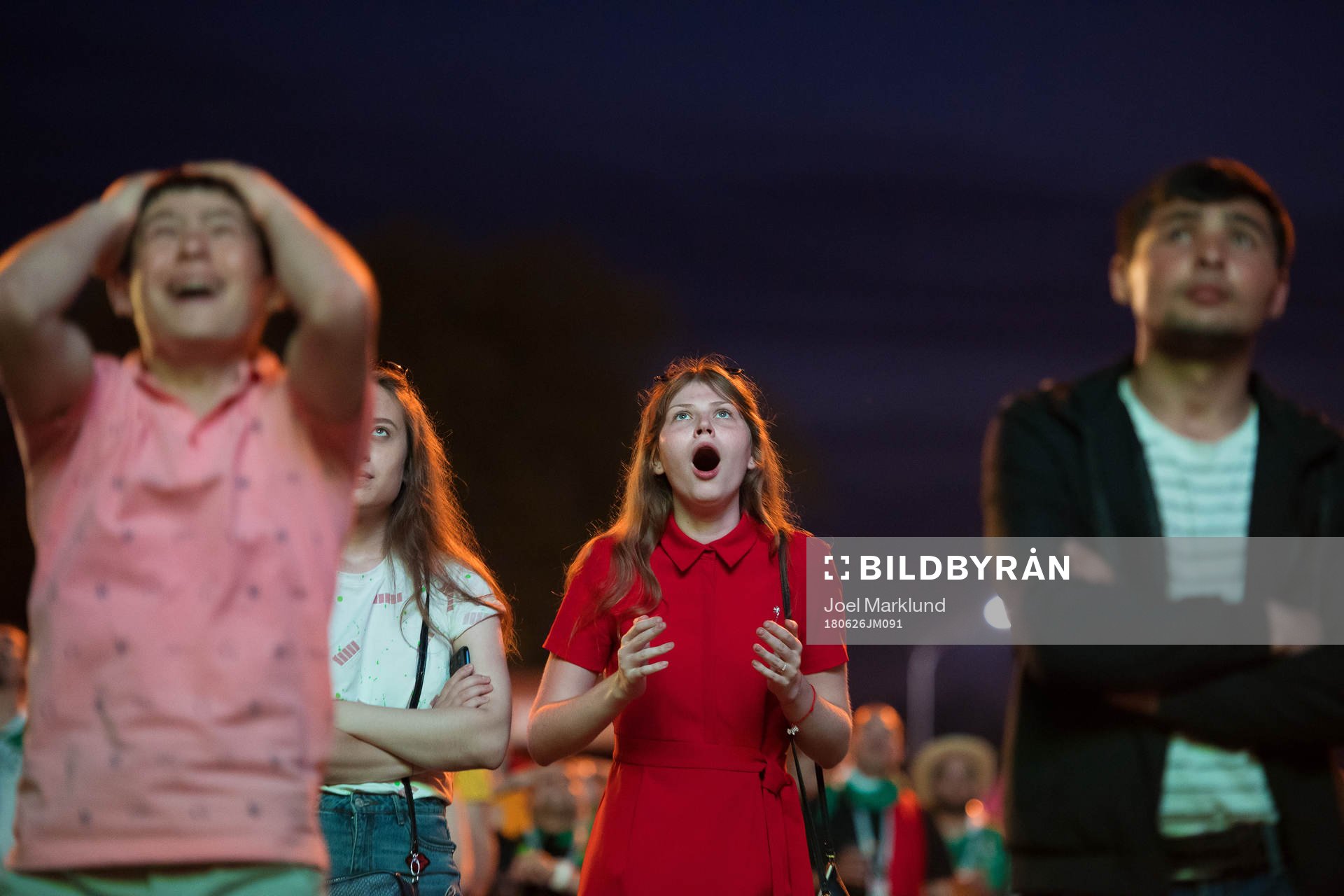Fans react when they watch the group stage match between