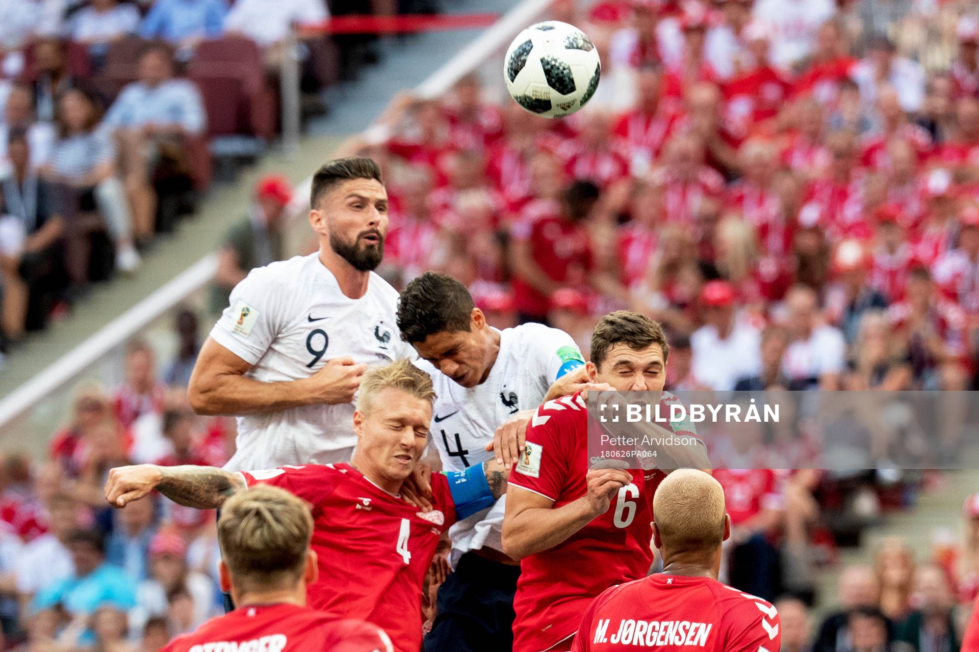 Olivier Giroud and Raphael Varane of France and Simon Kjaer