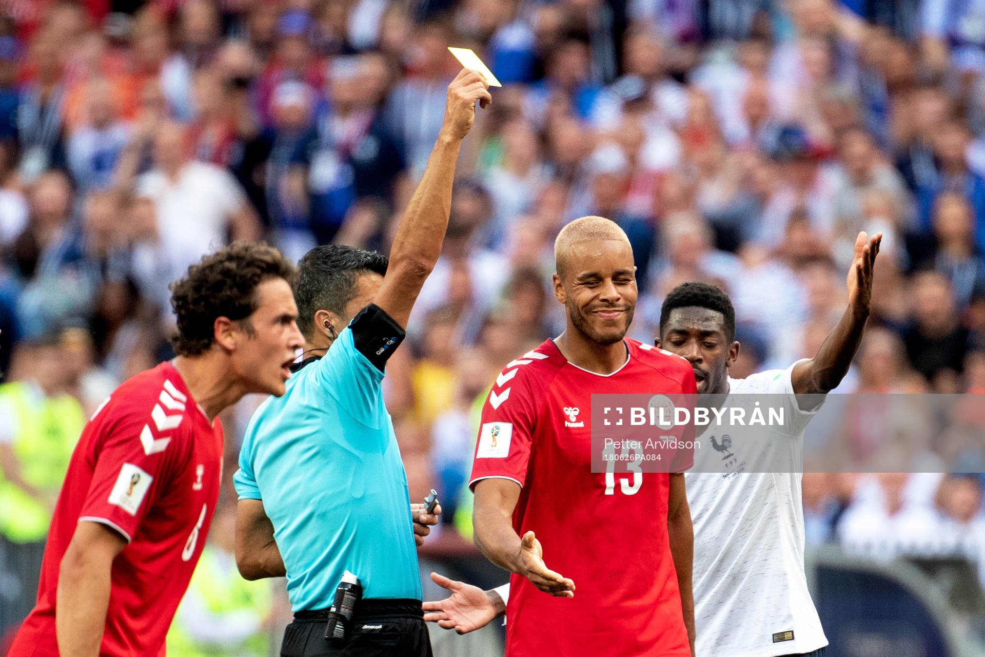 Mathias Jørgensen of Denmark is shown a yellow card