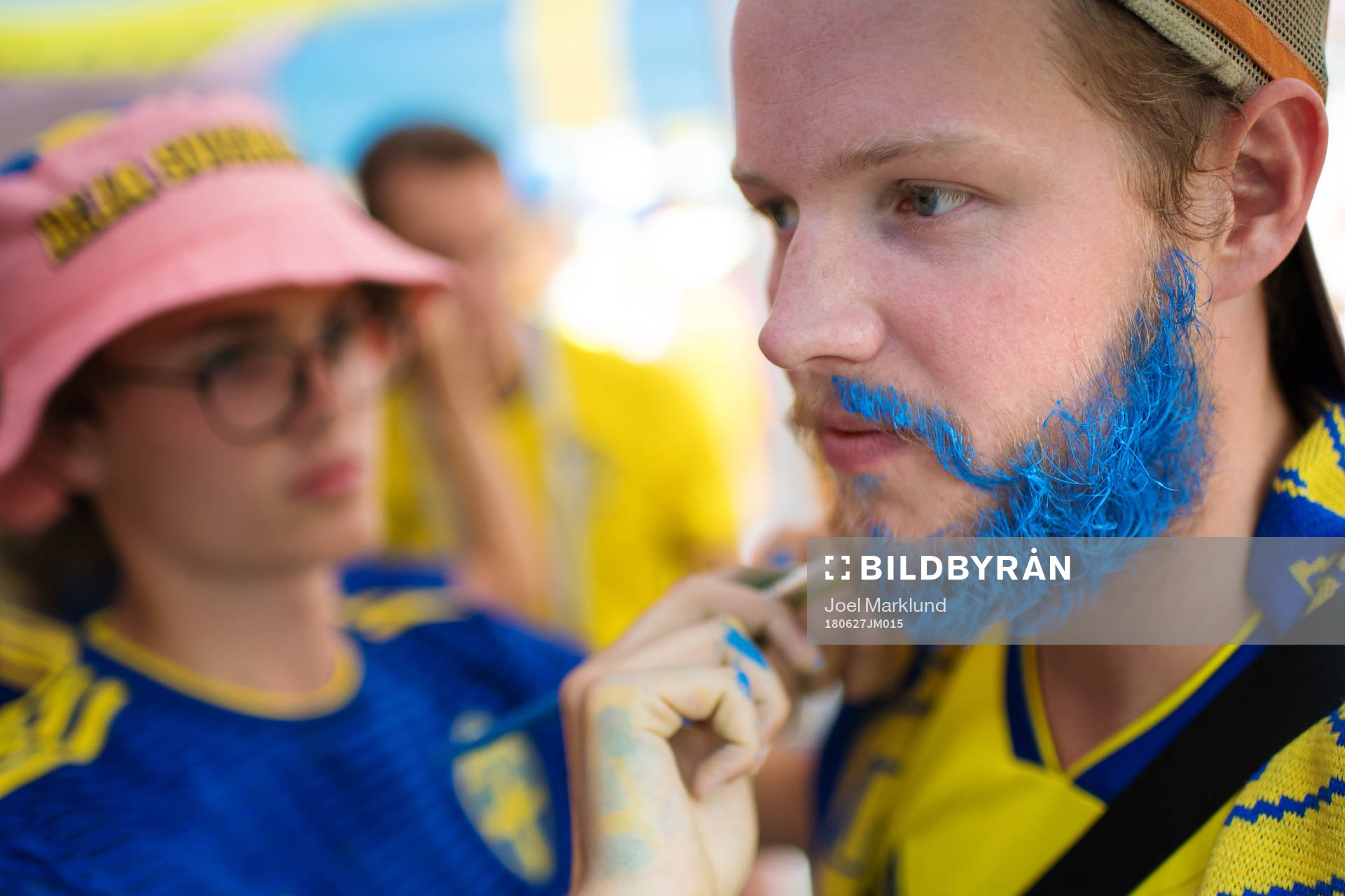 A Swedish fan get his beard painted