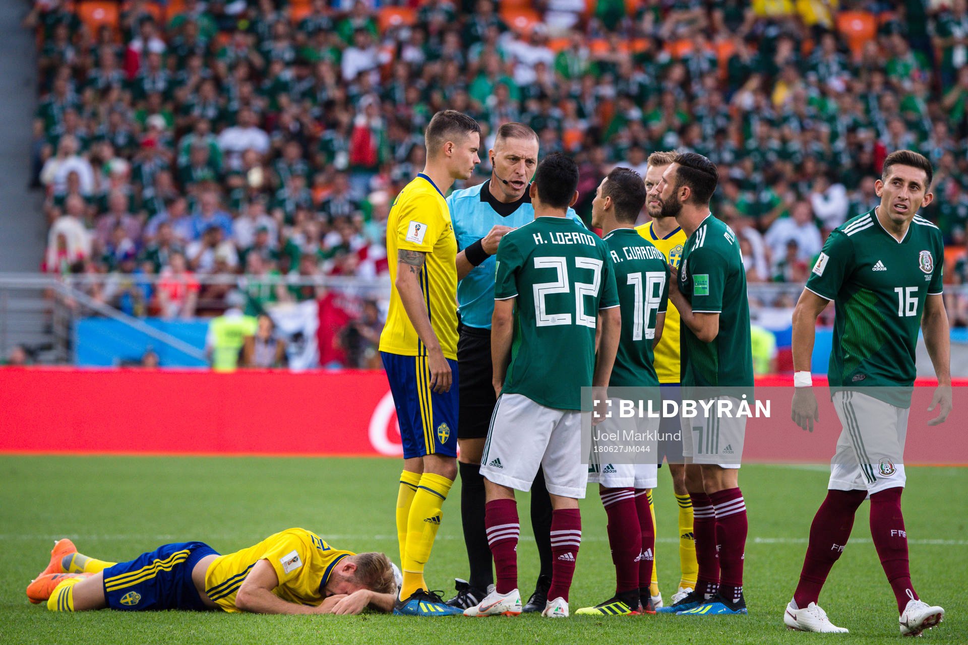 Mikael Lustig of Sweden with Referee Nestor Pitana