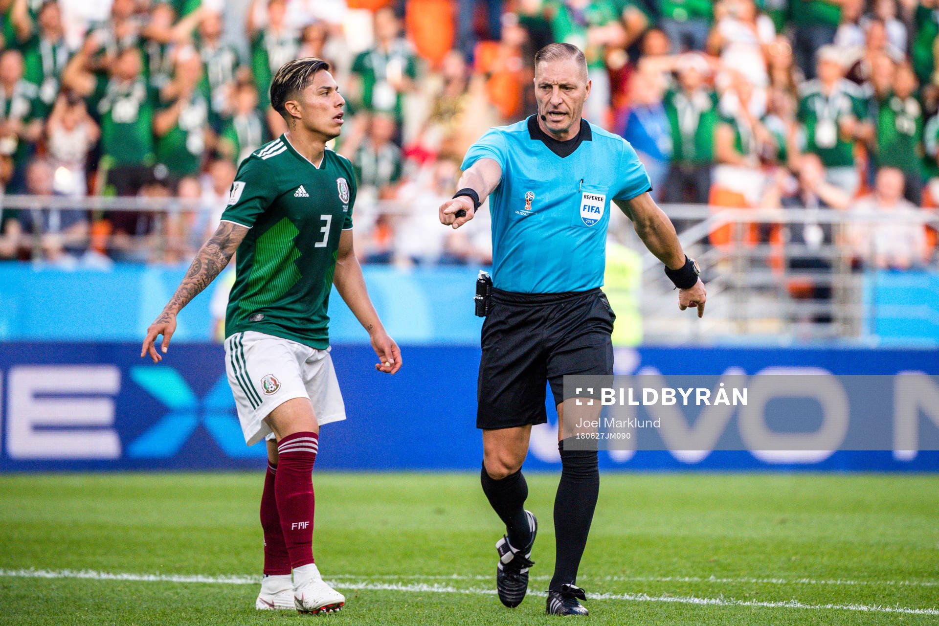 Carlos Salcedo of Mexico looks dejected next to Referee