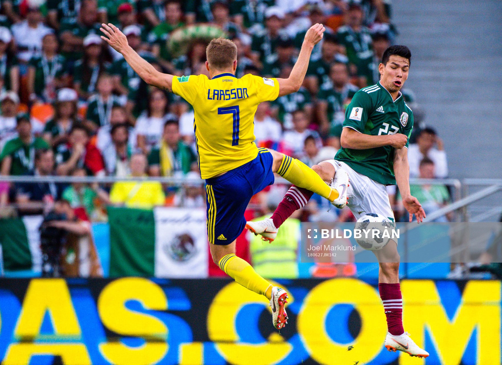 Sebastian Larsson of Sweden and Hirving Lozano of Mexico