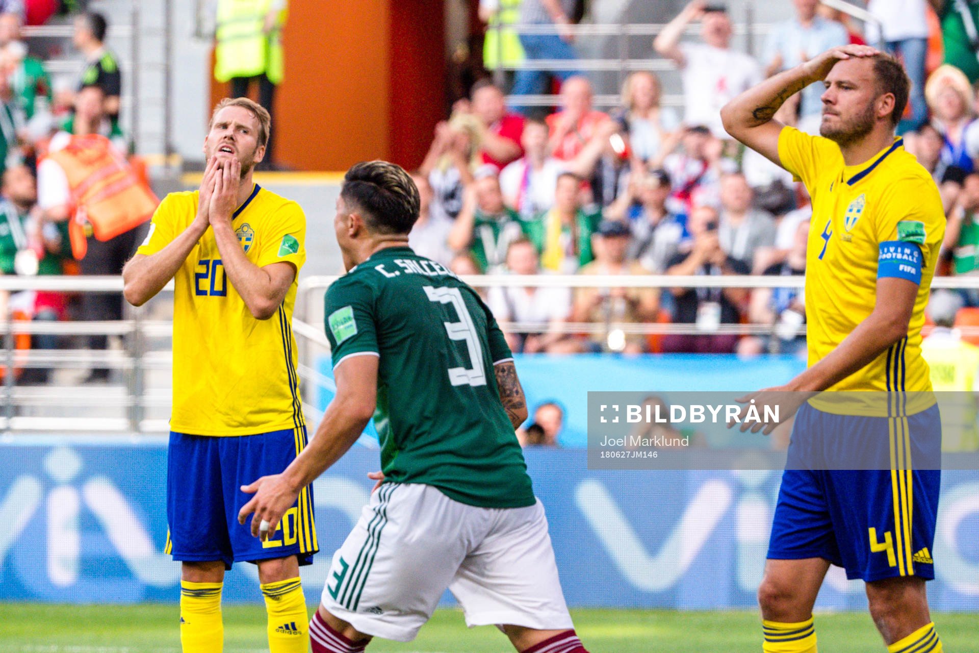 Ola Toivonen and Andreas Granqvist of Sweden looks dejected