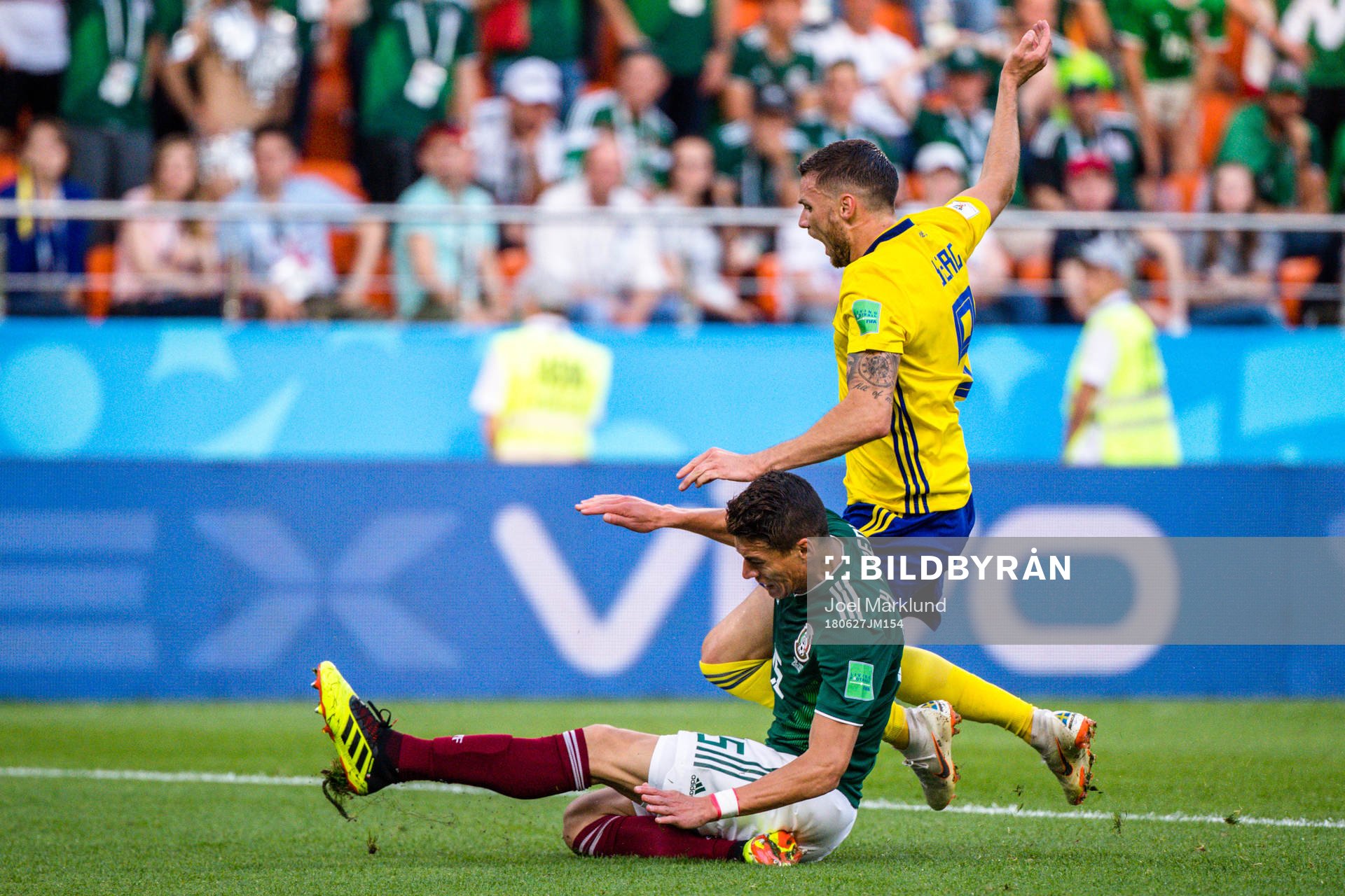 Hector Moreno of Mexico and Marcus Berg of Sweden