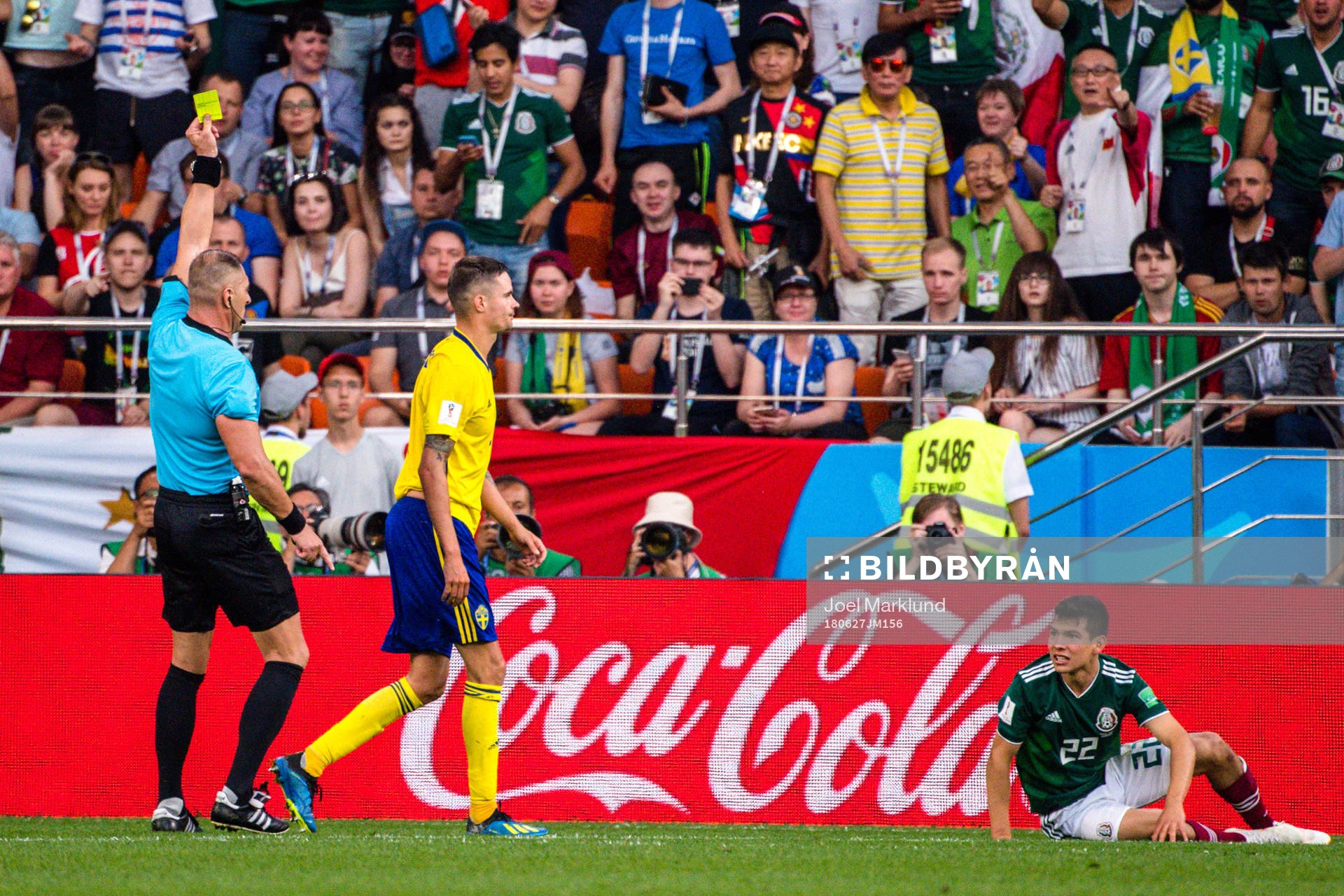 Mikael Lustig of Sweden receives a yellow card