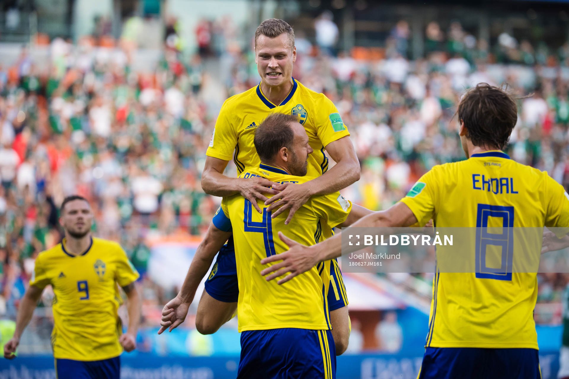 Viktor Claesson jumps onto Andreas Granqvist of Sweden
