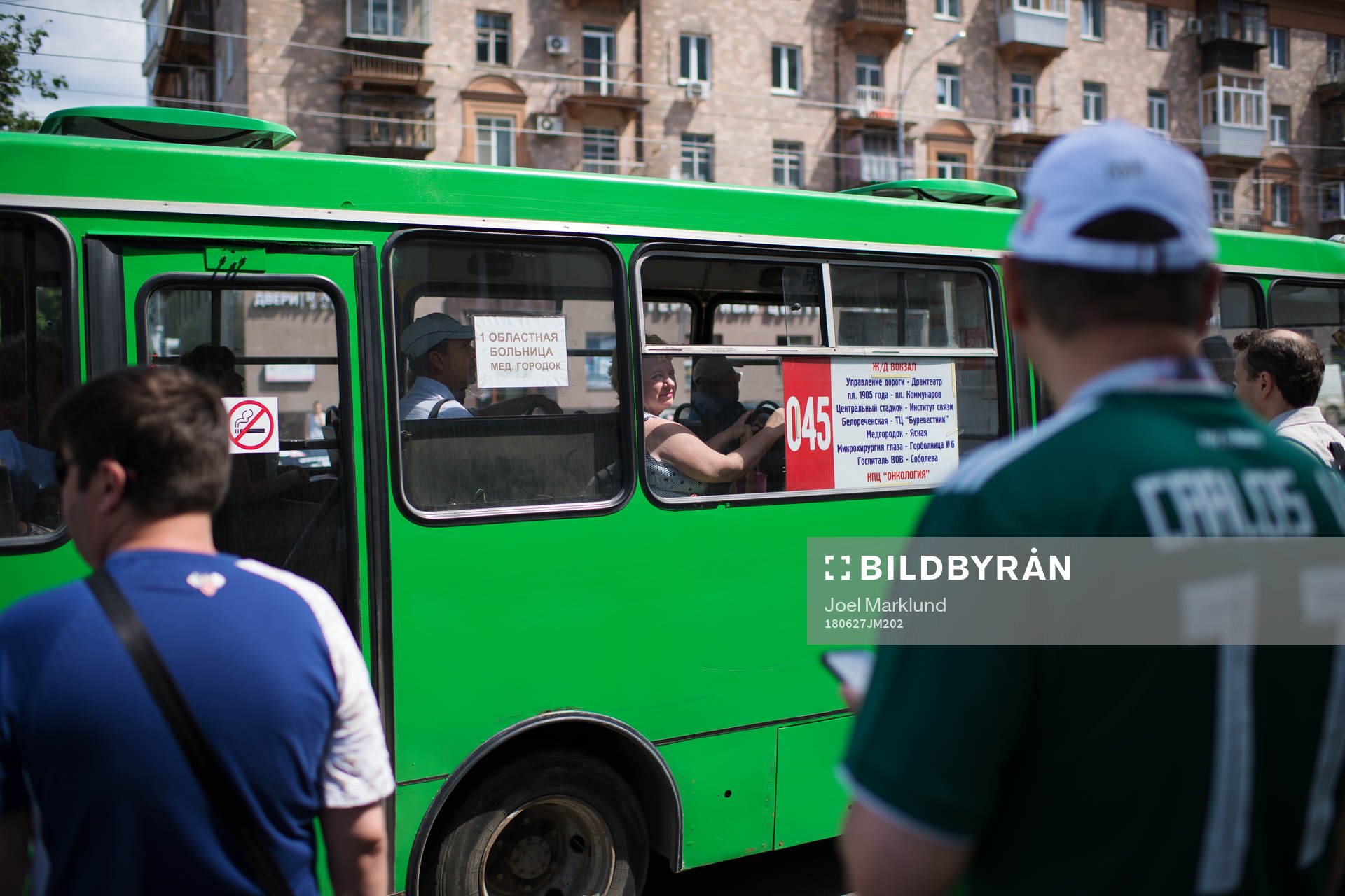 A woman peeks ut from a bus