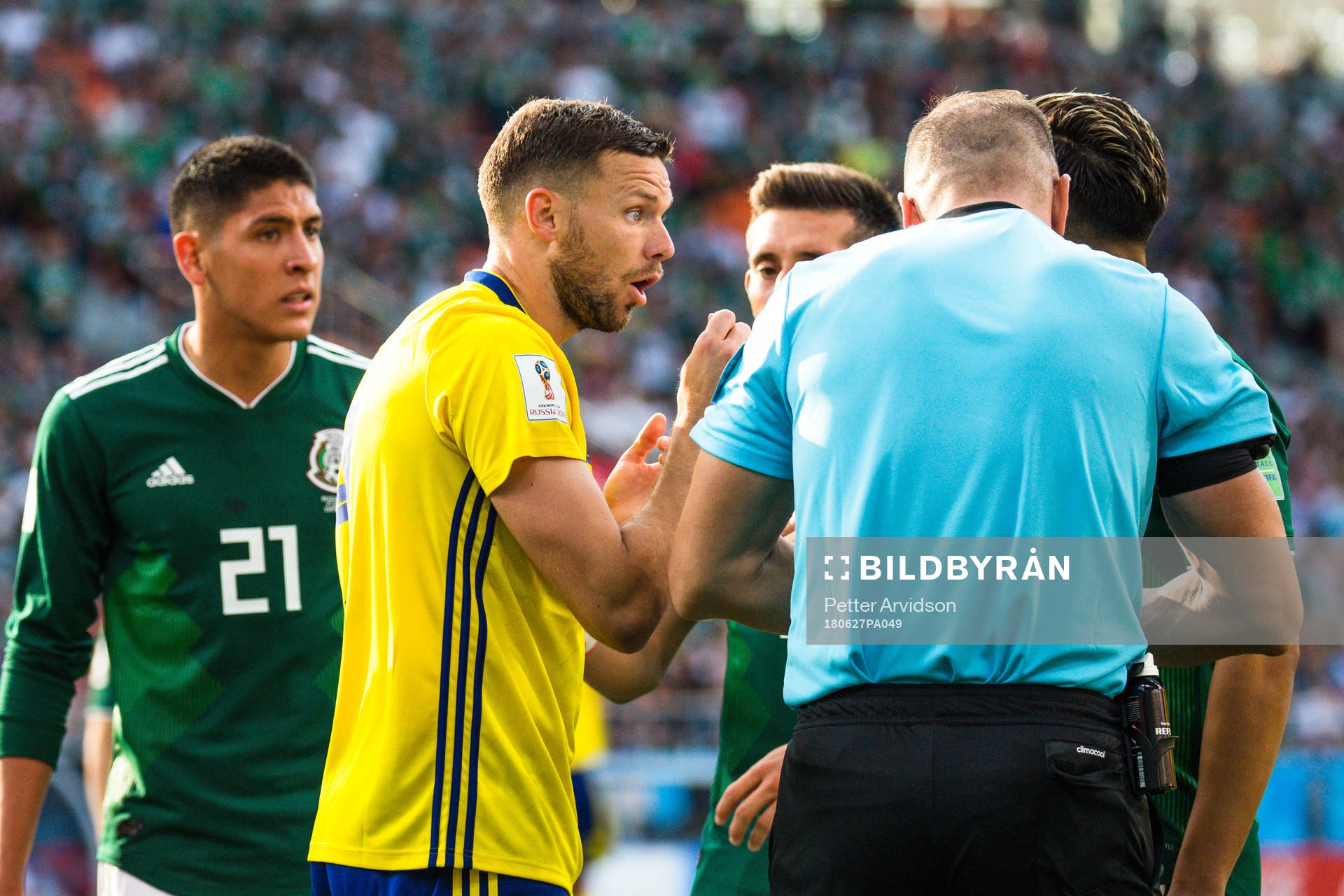 Marcus Berg of Sweden with Referee Nestor Pitana