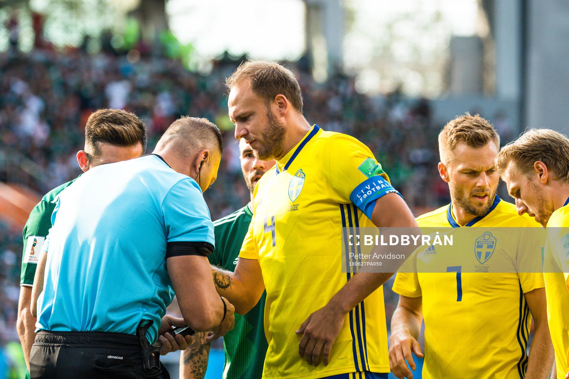 Andreas Granqvist of Sweden with Referee Nestor Pitana