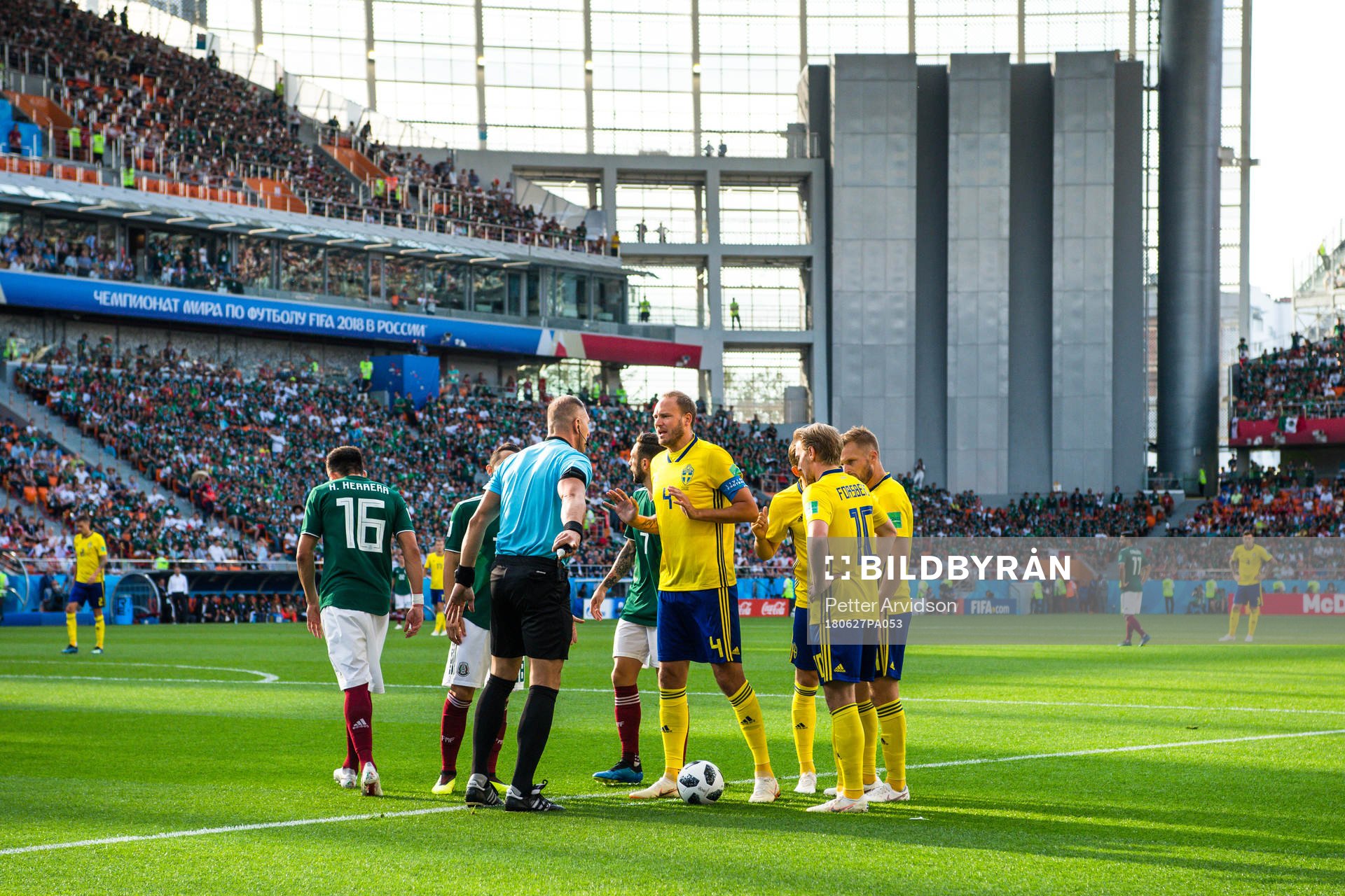 Referee Nestor Pitana and Andreas Granqvist of Sweden