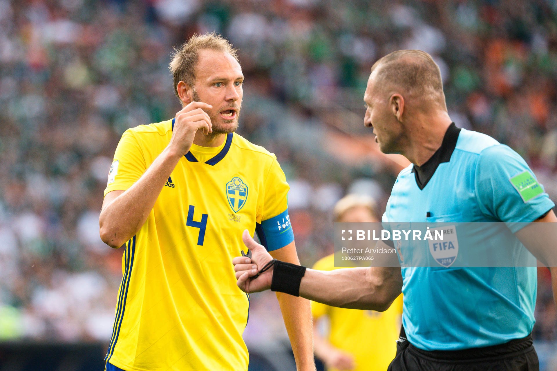 Andreas Granqvist of Sweden and Referee Nestor Pitana