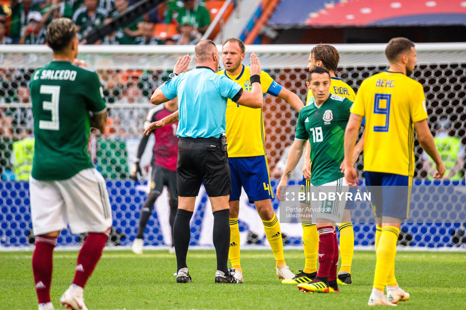 Referee Nestor Pitana and Andreas Granqvist of Sweden